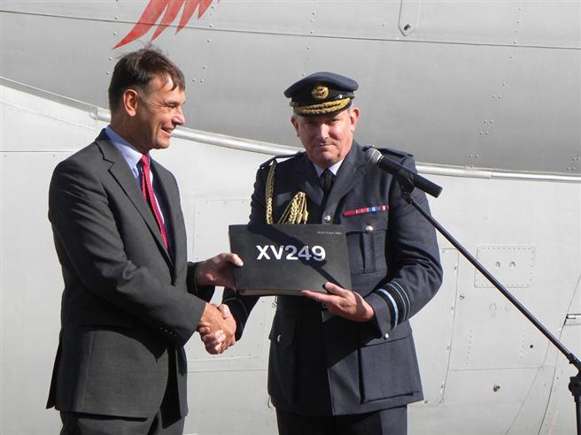 Air Marshal Sir Kevin Leeson hands over the log book to Museum Director General Peter Dye.