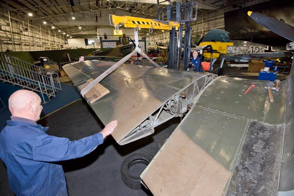 Members of the MBCC carefully detaching the wing from the Hawker Hurricane Members of the MBCC carefully detaching the wing from the Hawker Hurricane