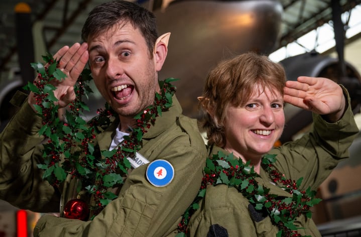 Two elf cadets in military uniforms salute you.