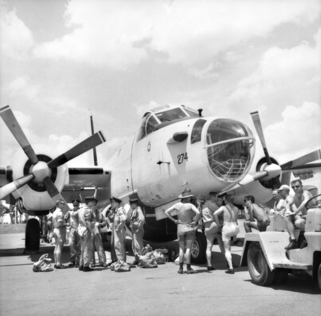 Australian and US crews around the nose of an RAAF Lockheed Neptune of No. 10 Squadron c. 1965. (Source: Australian War Memorial) Australian and US crews around the nose of an RAAF Lockheed Neptune of No. 10 Squadron c. 1965. (Source: Australian War Memorial)