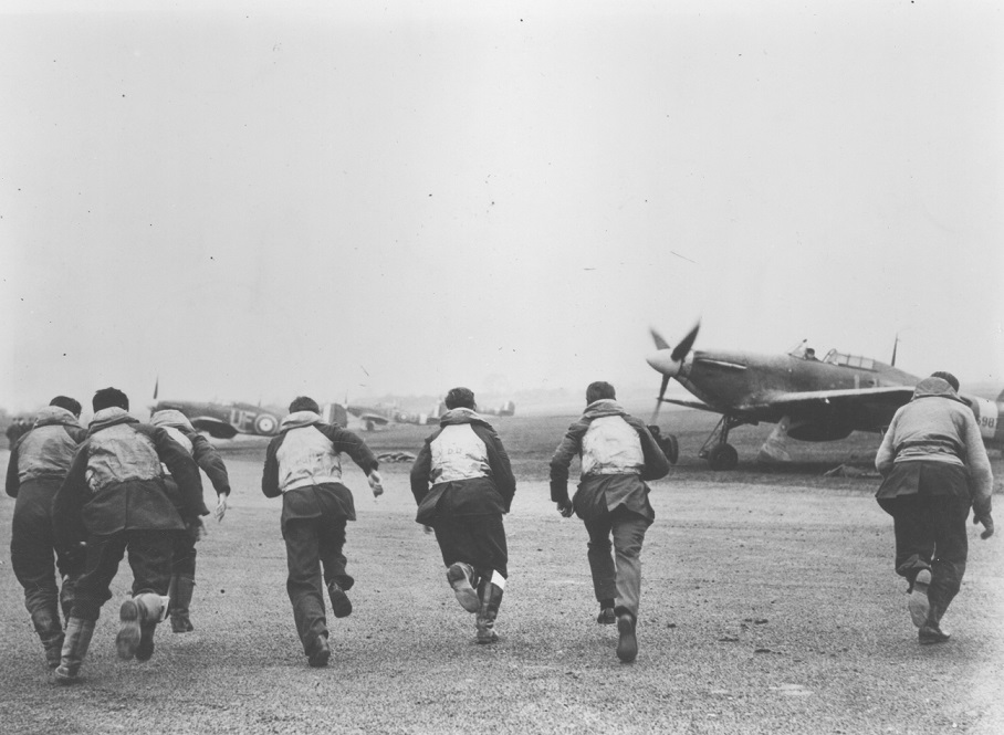 Pilots scrambling towards their aircraft.