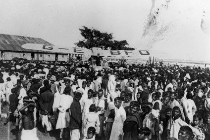 Alan Cobham in his de Havilland D.H.50 surrounded by crowds. Alan Cobham in his de Havilland D.H.50 surrounded by crowds.